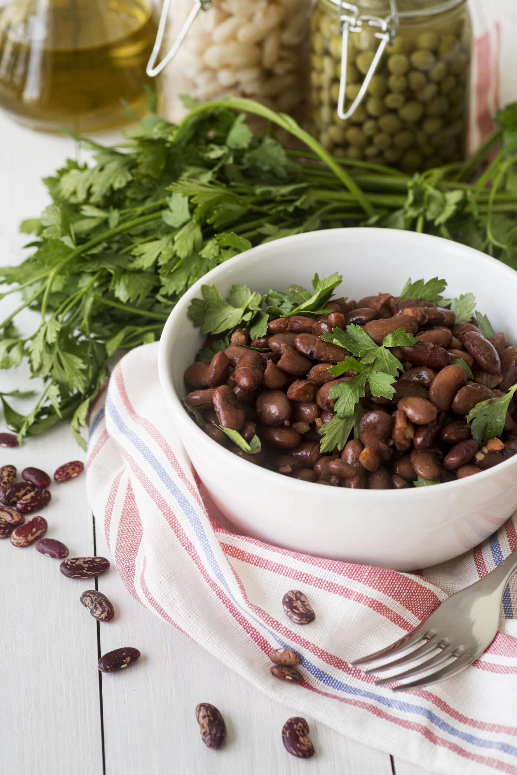 Ingredients for homemade baked beans, including navy beans, molasses, and smoked paprika